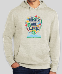 Person wearing a heather oatmeal pullover hoodie featuring a colorful "Libraries Are Life!" graphic on the chest, showing an open book with whimsical icons including plants, scissors, a rainbow, a hot air balloon, and a sun bursting from its pages.