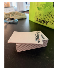 Stack of small white notepads printed with the phrase “Libraries ARE LIFE!!!” The word "libraries" is in cursive.