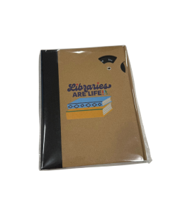 Brown notebook wrapped in plastic packaging with a black spine and a printed “Libraries Are Life!” graphic featuring stacked books on the front cover.