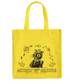 Bright yellow reusable tote bag featuring black illustrations of Inspector Whiskers holding a magnifying glass, surrounded by detective-themed clues. One side displays “Mysteries Await at Your Library” in English, while the reverse features “Misterios te Esperan en tu Biblioteca” in Spanish.