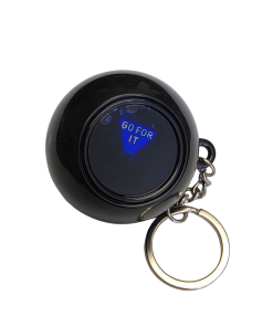 Black spherical fortune teller keychain with a glossy finish and silver metal chain and key ring. A circular window on the front displays a blue triangle with the message “GO FOR IT” in white lettering.