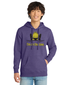 Model wearing a heather purple pullover hoodie featuring Inspector Whiskers, a black cat detective peeking over a line in a yellow plaid deerstalker hat, with the phrase “I’m on the Case” printed below. Hoodie includes a drawstring hood and front kangaroo pocket.