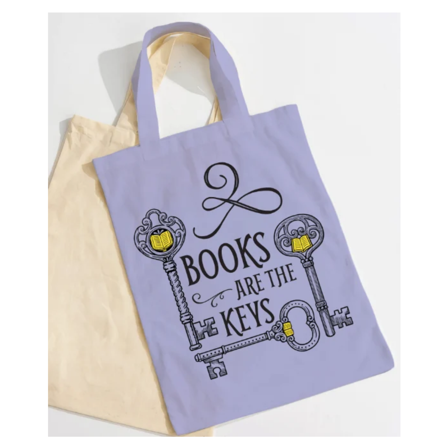 Lavender cotton tote bag reading "Books Are the Keys" with three ornate antique keys featuring open-book designs