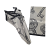 White scarf with a black border and a pattern of ornate antique keys with open-book designs, shown folded and draped