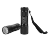 Two black mini LED flashlights with textured grips, shown upright and lying horizontally to display the LED bulbs. One features the white “Mysteries Await at Your Library” slogan with paw print accents and an attached black wrist strap.