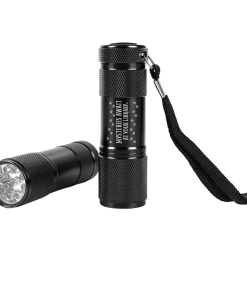 Two black mini LED flashlights with textured grips, shown upright and lying horizontally to display the LED bulbs. One features the white “Mysteries Await at Your Library” slogan with paw print accents and an attached black wrist strap.