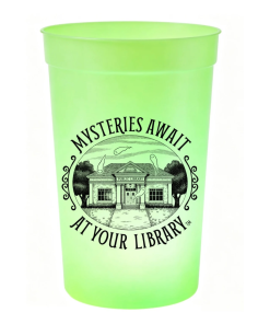 Bright green glow-in-the-dark plastic cup featuring black “Mysteries Await at Your Library” artwork with a public library surrounded by friendly ghosts.