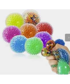 Assortment of colorful, translucent, round sensory fidget balls covered in soft, flexible spikes. Balls are shown in bright green, blue, purple, pink, orange, and red, with a hand squeezing several to demonstrate their squishy texture.