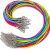 Bulk assortment of brightly colored necklace cords in red, pink, purple, blue, green, yellow, and orange, arranged in a curved bundle. Each cord features silver-tone metal end caps, lobster clasps, and extension chains for adjustable sizing. Shown against a clean white background.