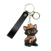 3D Inspector Whiskers keychain featuring a black detective cat with yellow eyes, pink ears, a brown detective hat and cape, and a tiny magnifying glass. Attached to a gold-tone metal clasp with a black wrist strap.